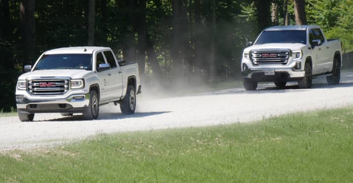 2 Trucks Driving on Dirt Road